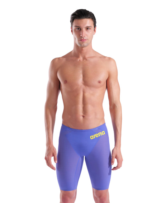 A man with short dark hair faces forward, wearing the Arena Men's Powerskin Carbon Air2 Jammer - Limited Edition - Eclipse Glare with yellow 