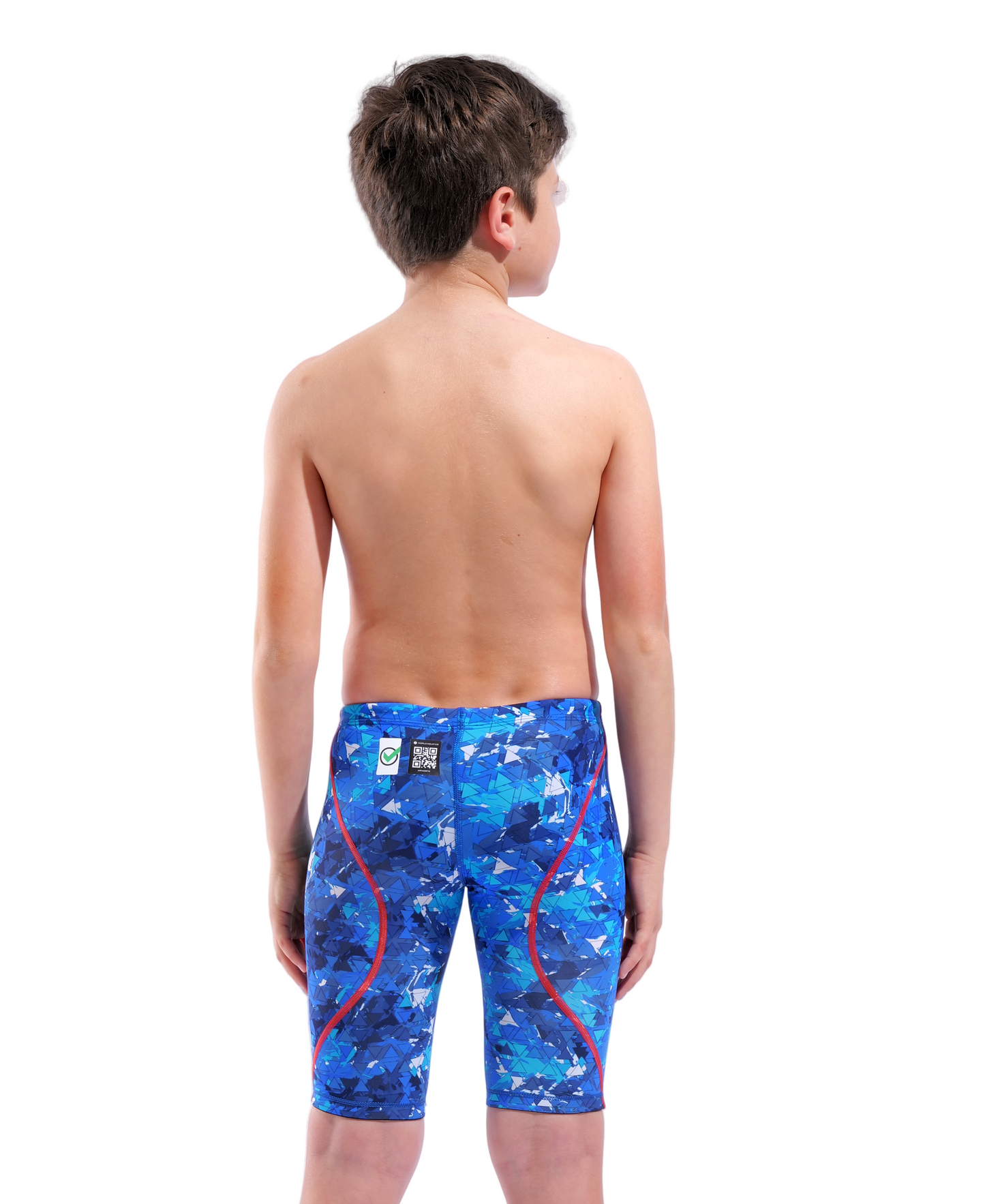 A boy with short brown hair stands shirtless, facing away, wearing Arena Boys Powerskin ST Next Jammer - Limited Edition - Splashy by Arena, featuring blue geometric patterns, red seams, and recycled fabric.